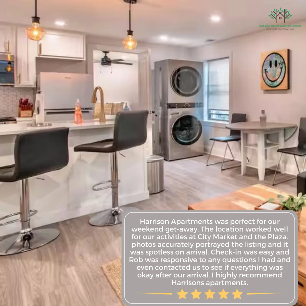 A view that combines the kitchen island with bar stools, a dining table set for meals, and modern laundry appliances in the background. Sunlight streams in, illuminating stylish surfaces and offering a glimpse of vibrant communal activity.